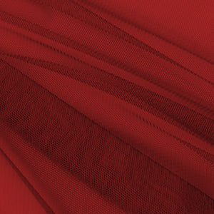 Close-up of deep red sheer mosquito netting fabric, revealing fine mesh and soft folds, perfect for outdoor gazebo sidewall curtains.