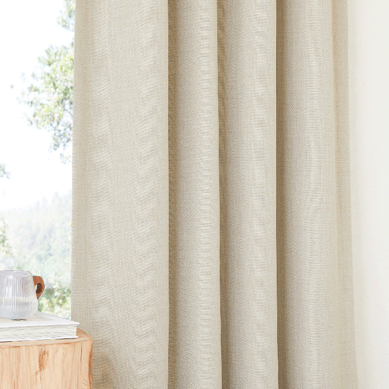 Detailed view of a textured beige plain blackout curtain panel, highlighting its subtle weave & elegant folds for living room & bedroom.