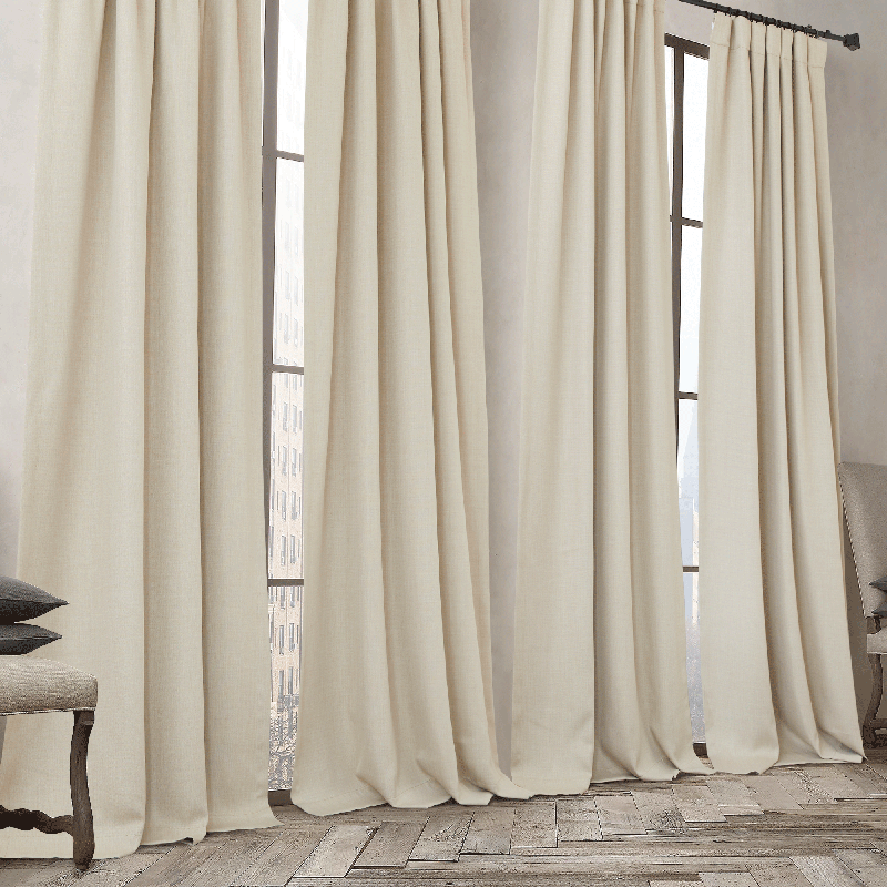 Two plain beige rod pocket & back tab blackout curtain panels, floor-length, styled for living room or bedroom windows.