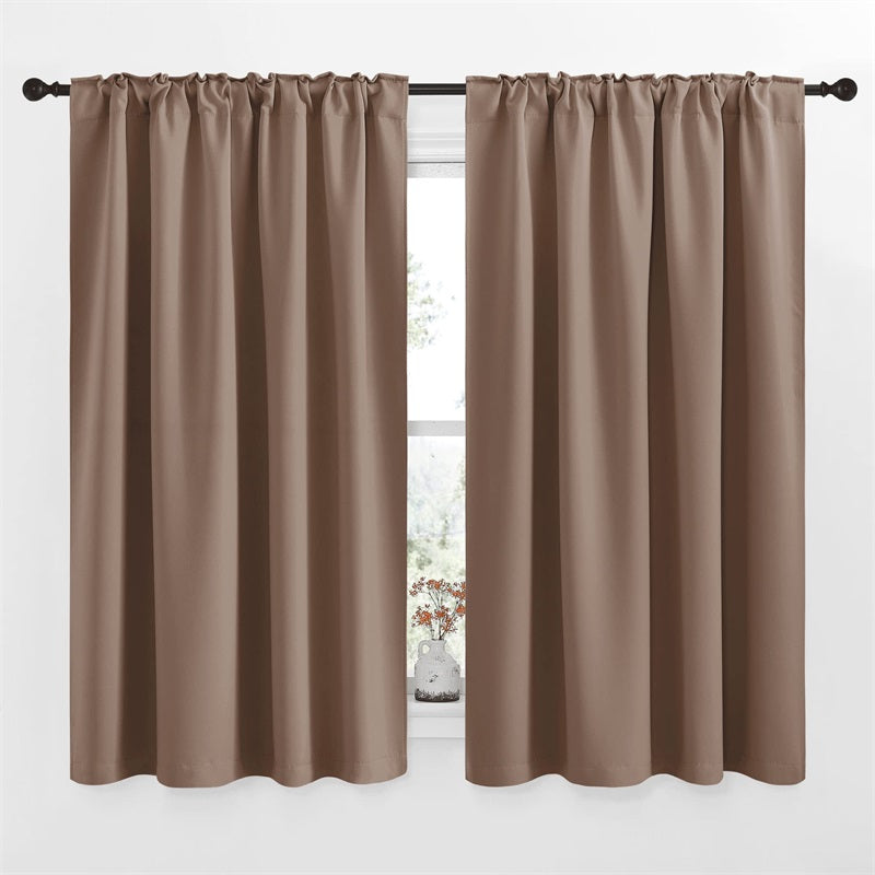 Two 52-inch wide taupe rod pocket & back tab blackout curtain panels on a rod for living room or bedroom.