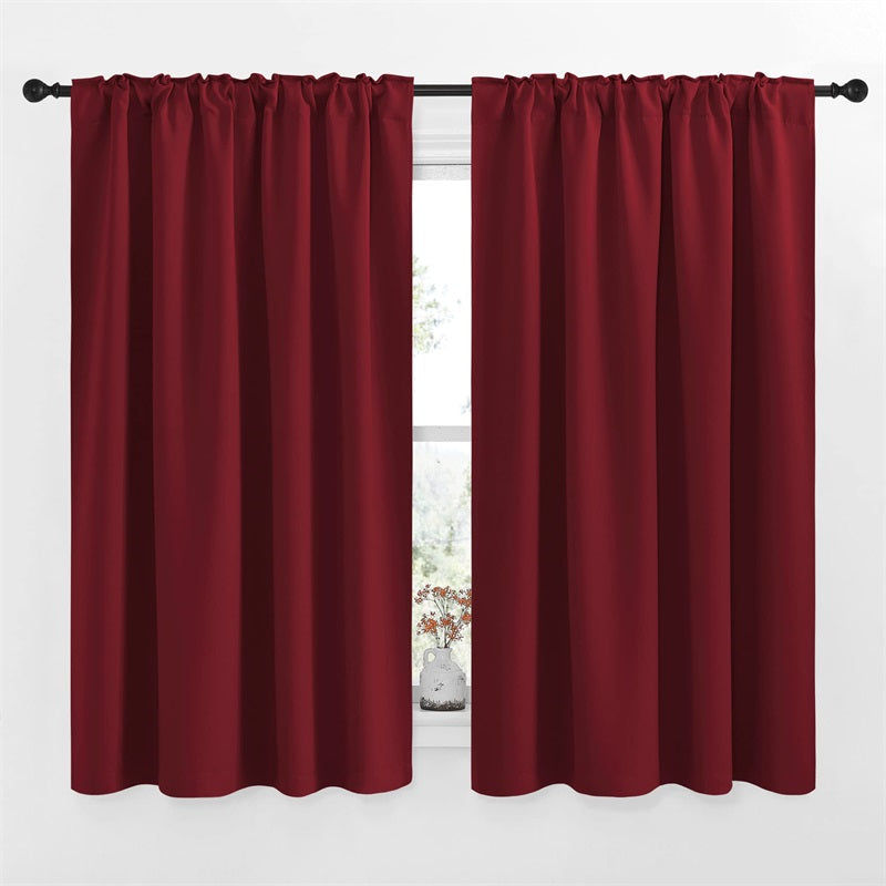 Two deep red 52-inch wide blackout curtain panels featuring rod pocket & back tab design, ideal for living room & bedroom.