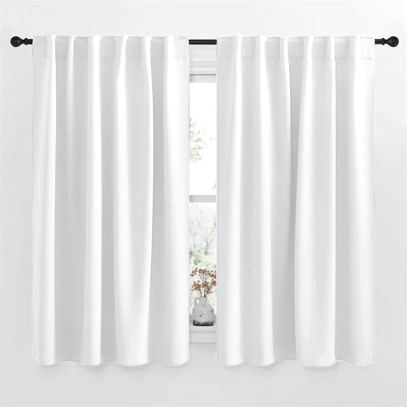 White 52-inch rod pocket & back tab blackout curtains, two panels on a black rod, providing stylish light control for living rooms/bedrooms.