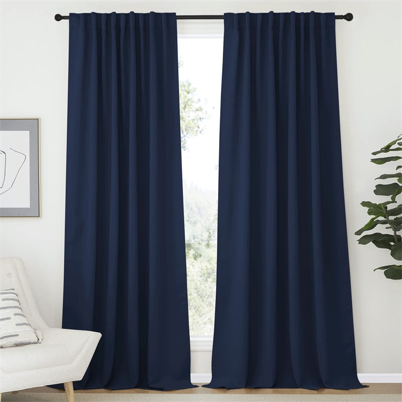 Two navy blue rod pocket & back tab blackout curtains (52 inch width) for living room or bedroom, hanging on a rod.