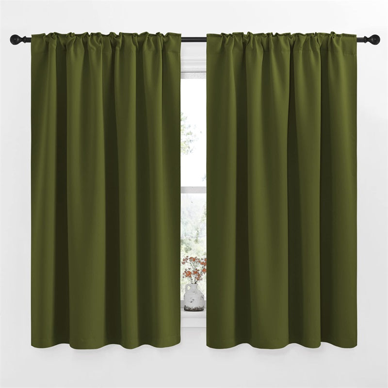 Two 52-inch olive green rod pocket & back tab blackout curtain panels on a window, perfect for living room and bedroom.