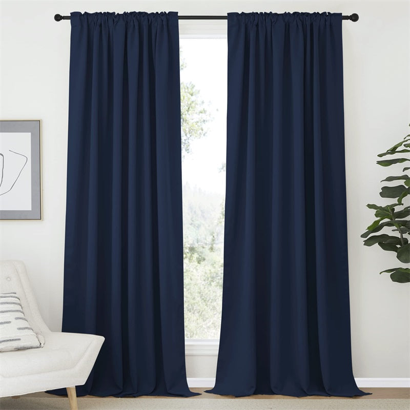 Two navy blue blackout curtains, rod pocket and back tab style, ideal for living room or bedroom privacy and light blocking.