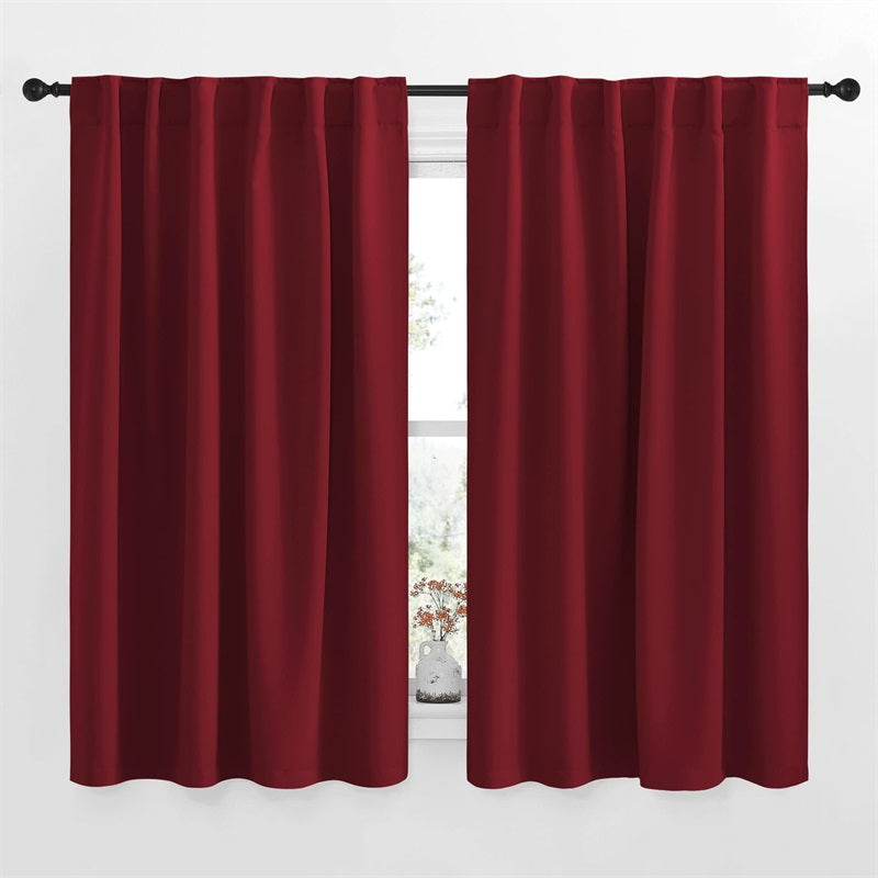 Two deep red 52-inch width blackout curtains with rod pocket and back tab hanging, perfect for living room and bedroom.