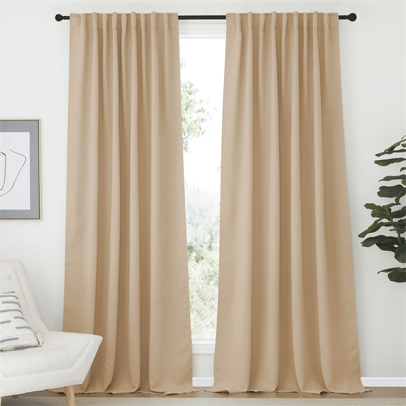 Beige 52-inch wide rod pocket blackout curtains (2 panels) in a modern living room or bedroom, with a chair.