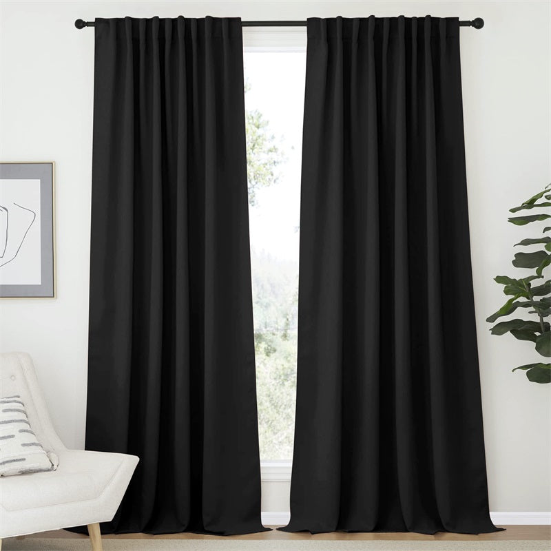 Two black 52-inch wide rod pocket & back tab blackout curtain panels for living room or bedroom.