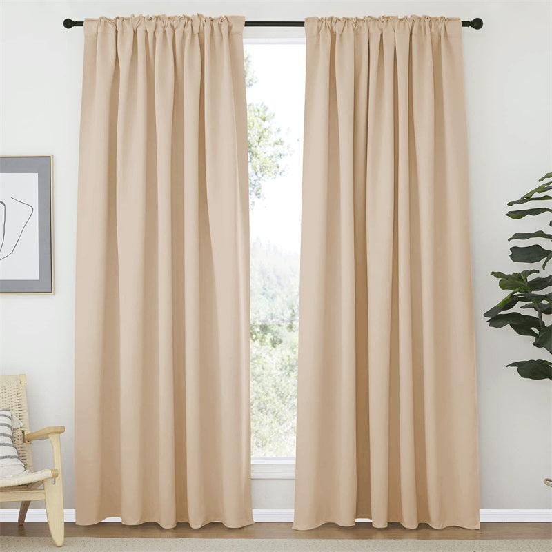 Warm beige rod pocket & back tab blackout curtains (2 panels, 52 inch width) installed on a black rod in a living room.