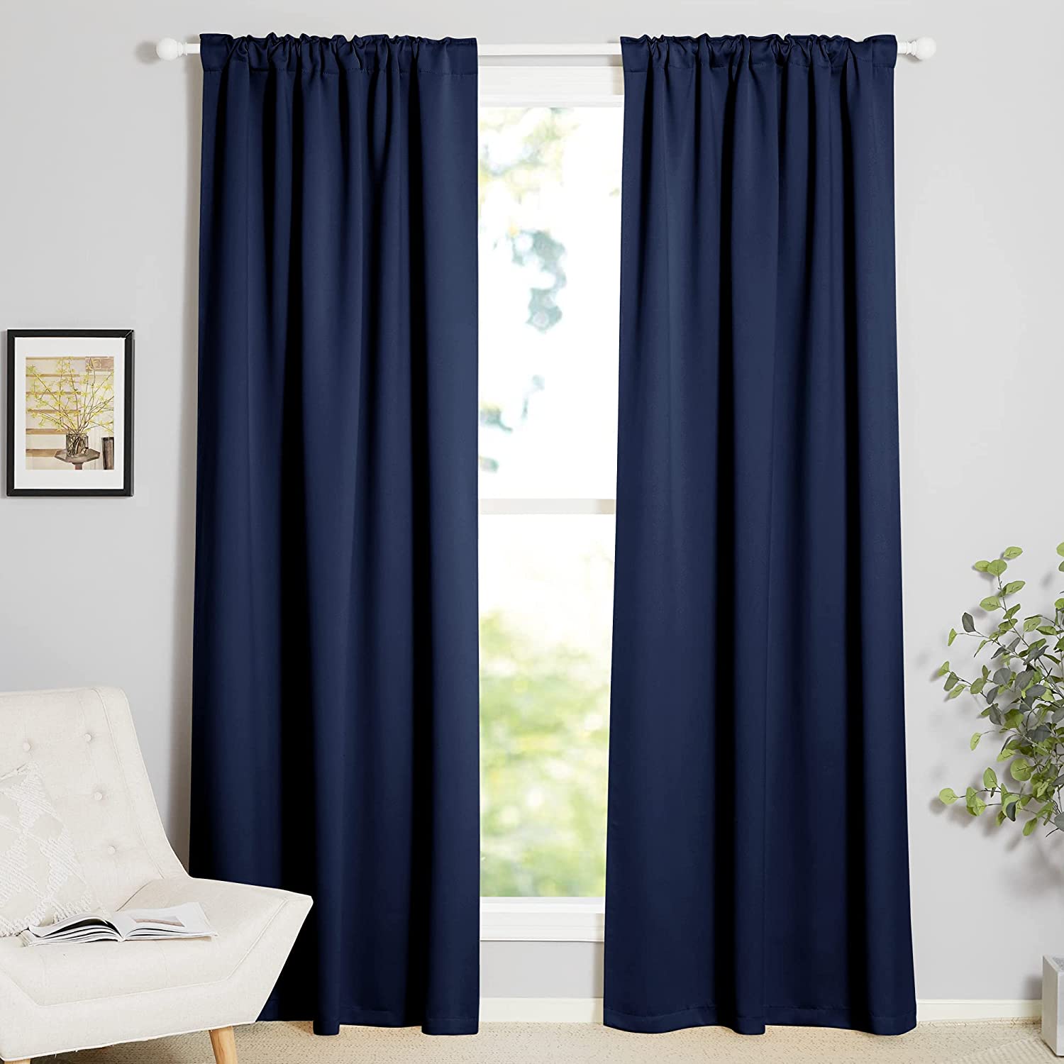 Two 70-inch wide navy blue rod pocket blackout curtains, thermal insulated, for living room or bedroom windows.