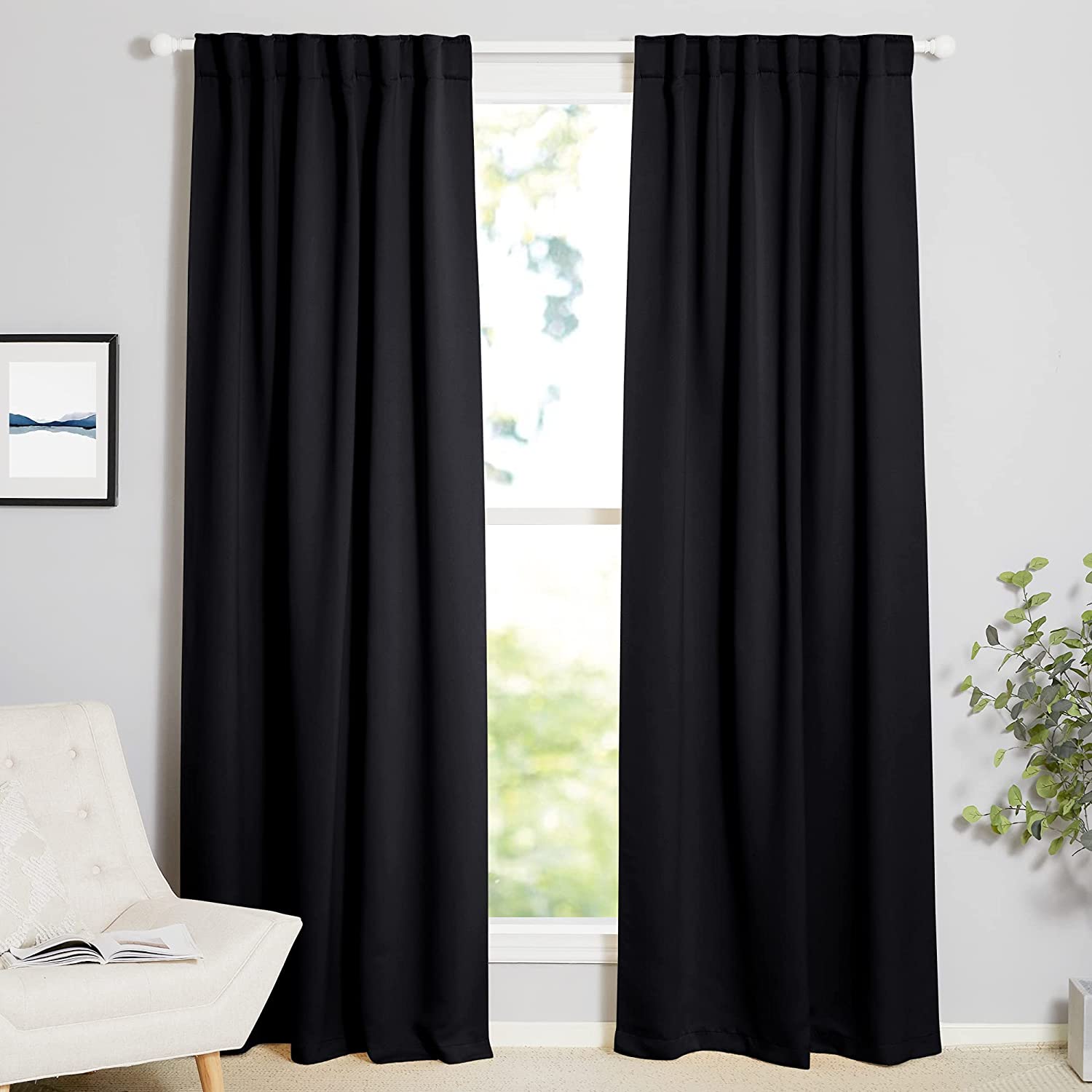 Two black 70-inch thermal insulated blackout curtain panels with rod pocket/back tab style in a living room window.