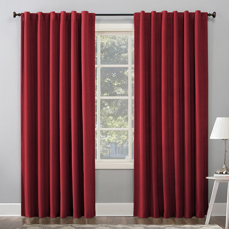 Two red thermal insulated blackout curtain panels with rod pocket & back tab hanging on a window rod for living room, bedroom.