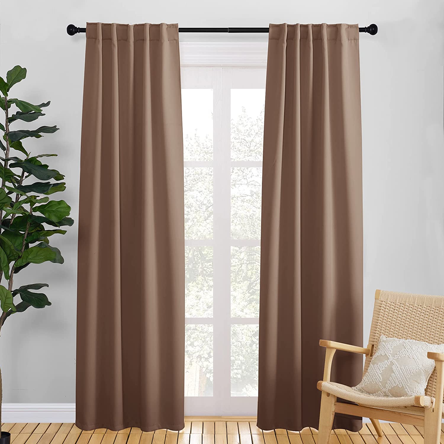 Two brown rod pocket & back tab thermal insulated blackout curtains covering a living room or bedroom window.