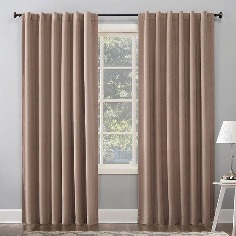 Two taupe thermal insulated blackout curtain panels, 70 inches wide, with rod pockets, partially open over a living room window.