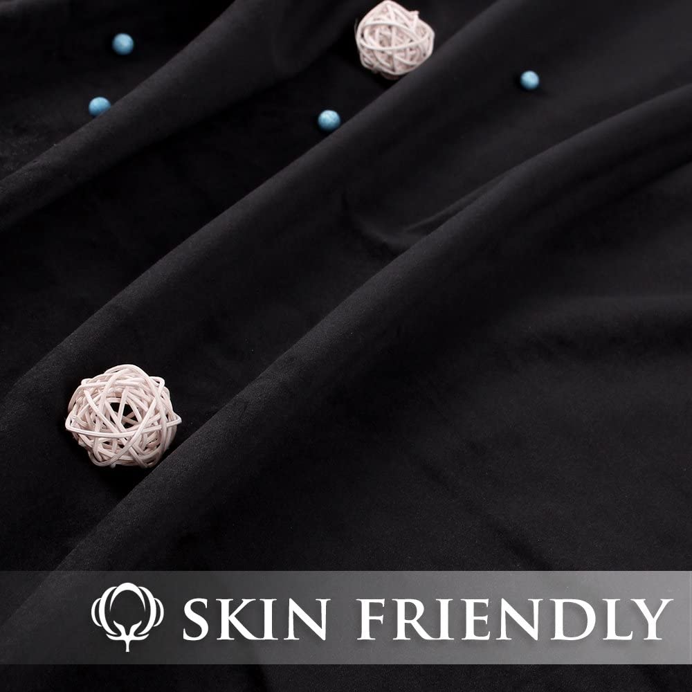 Close-up of rich black velvet blackout curtain fabric, showcasing its soft texture & drapes. Features "Skin Friendly" label.