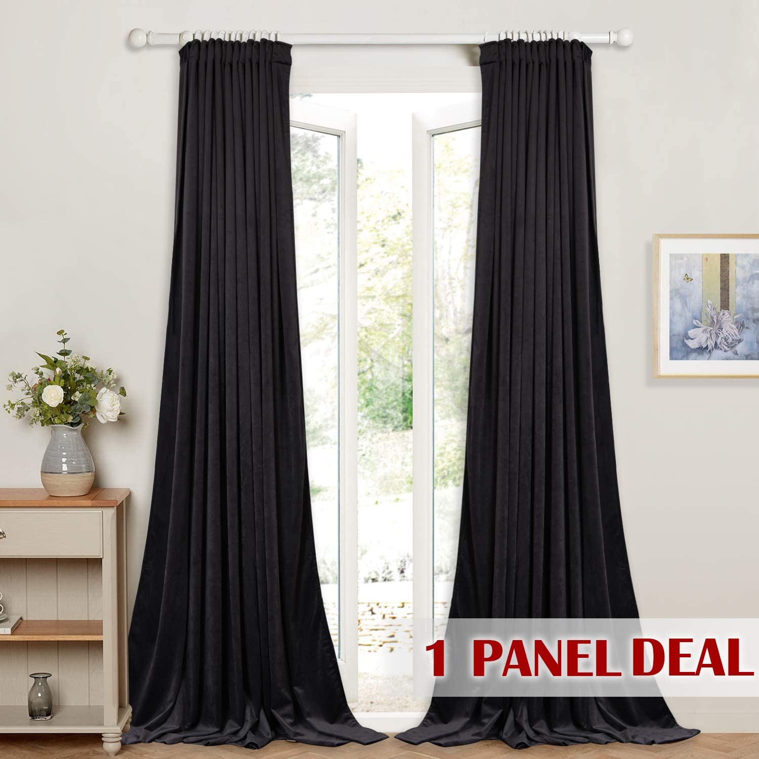 Rich black velvet rod pocket back tab blackout curtain panel framing a sliding glass door in a living room.