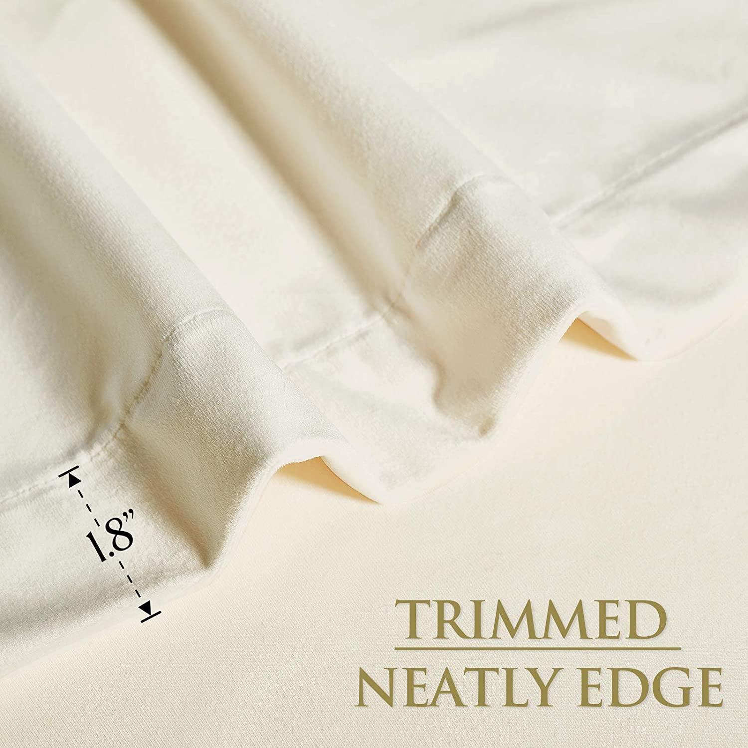Close-up of cream velvet blackout curtain fabric with a neatly trimmed 1.8-inch bottom hem, highlighting quality finish.