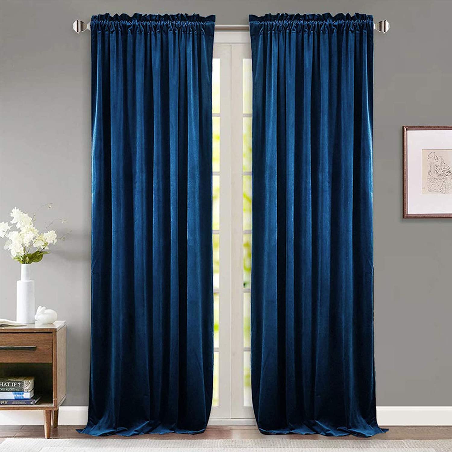 Pair of deep blue velvet rod pocket blackout curtains, perfect for noise reducing privacy in living room or bedroom.