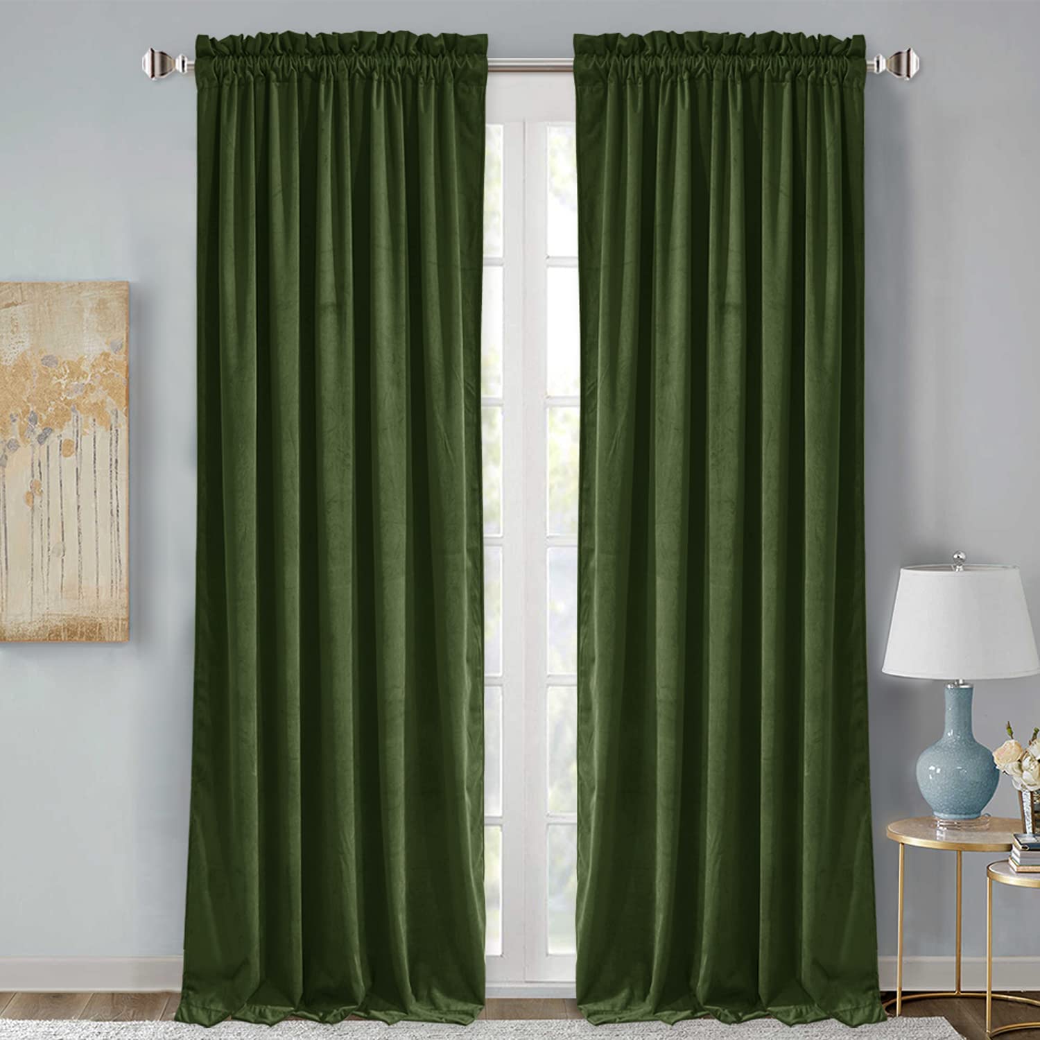 Two forest green rod pocket velvet blackout curtains for living room or bedroom, offering noise reduction.