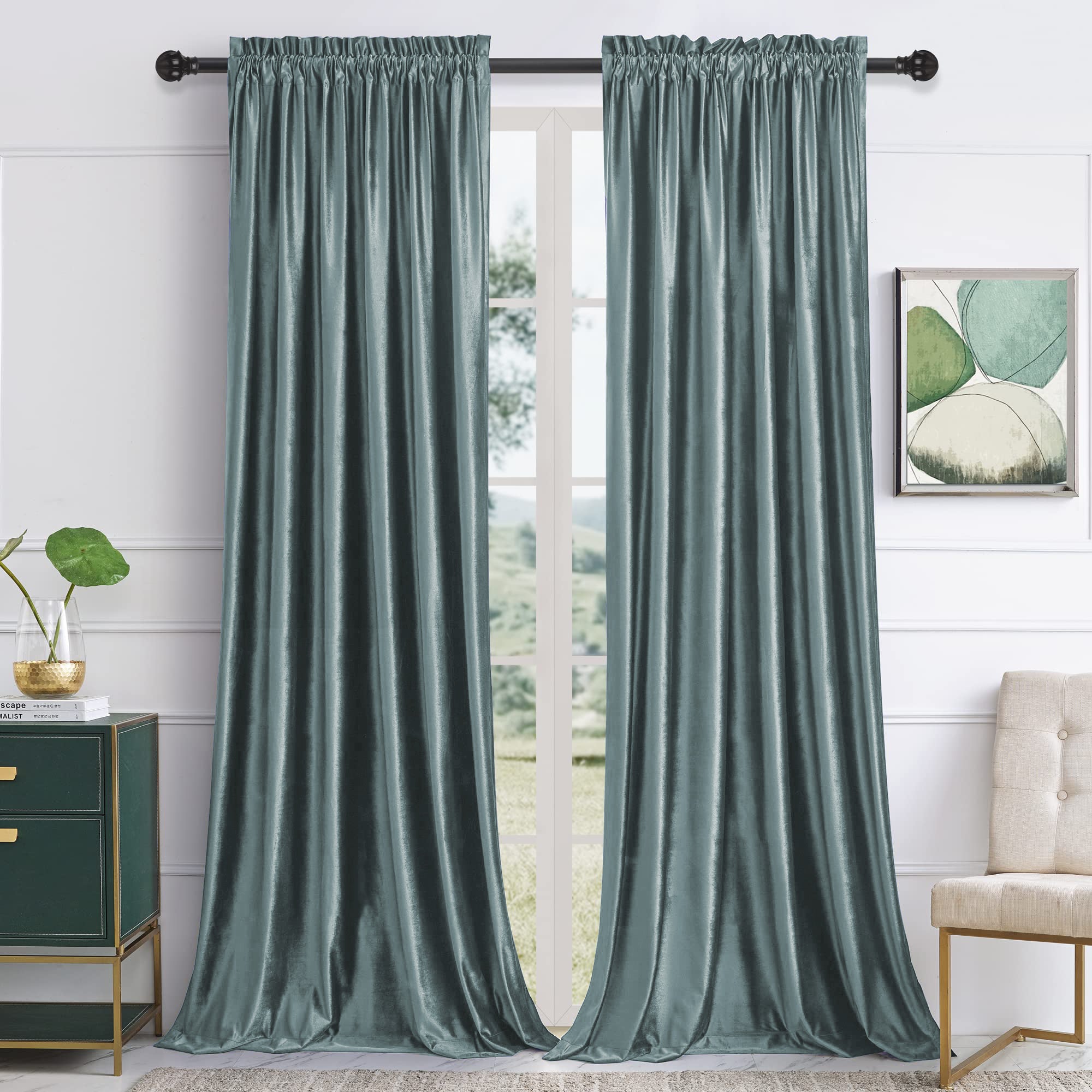 Two teal velvet rod pocket blackout curtains in a modern living room. Provide noise reduction, privacy, and an elegant drape.