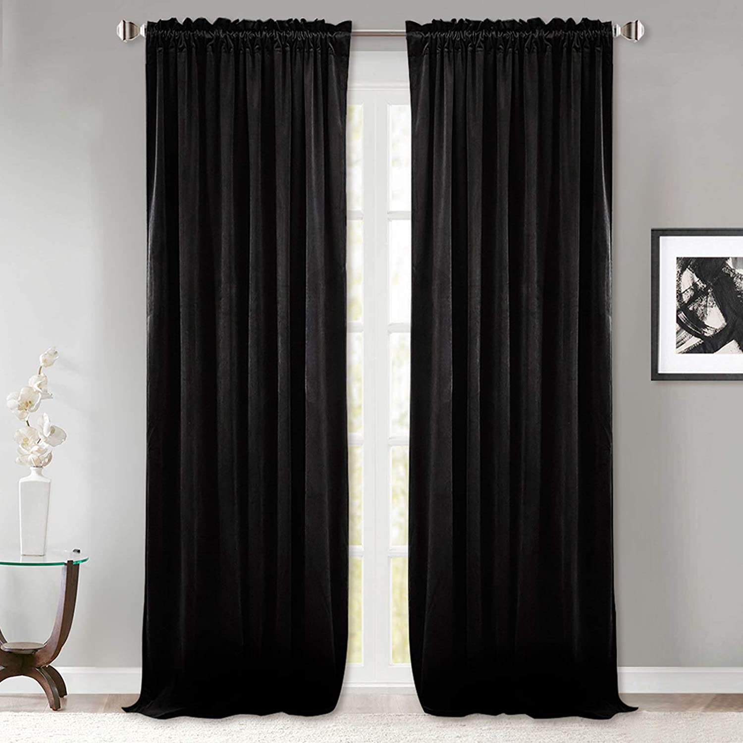 Black rod pocket velvet blackout curtains (2 panels) covering a window, perfect for a modern living room or bedroom.