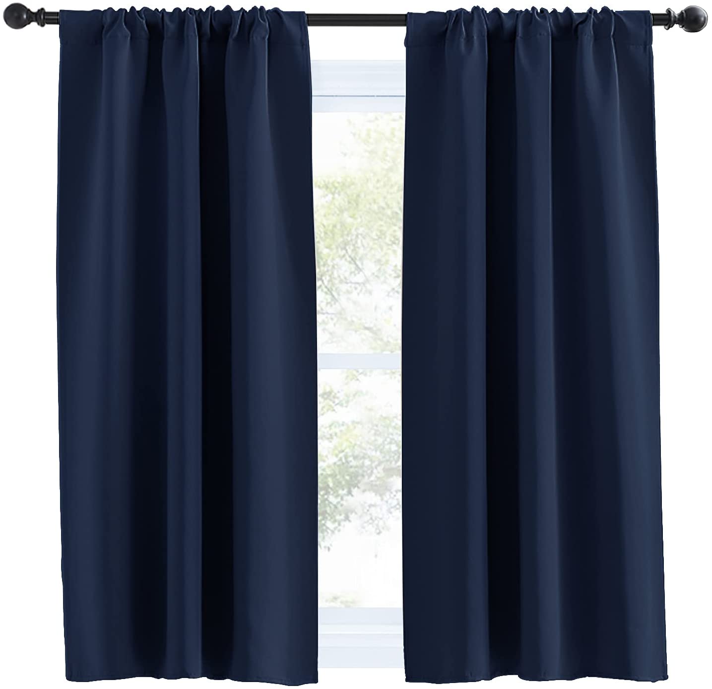 Two navy blue rod pocket thermal insulated blackout curtain panels covering a window, ideal for living room or bedroom.