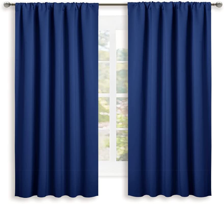 Navy blue rod pocket thermal insulated blackout curtains (2 panels) for living room or bedroom, fully covering a window.