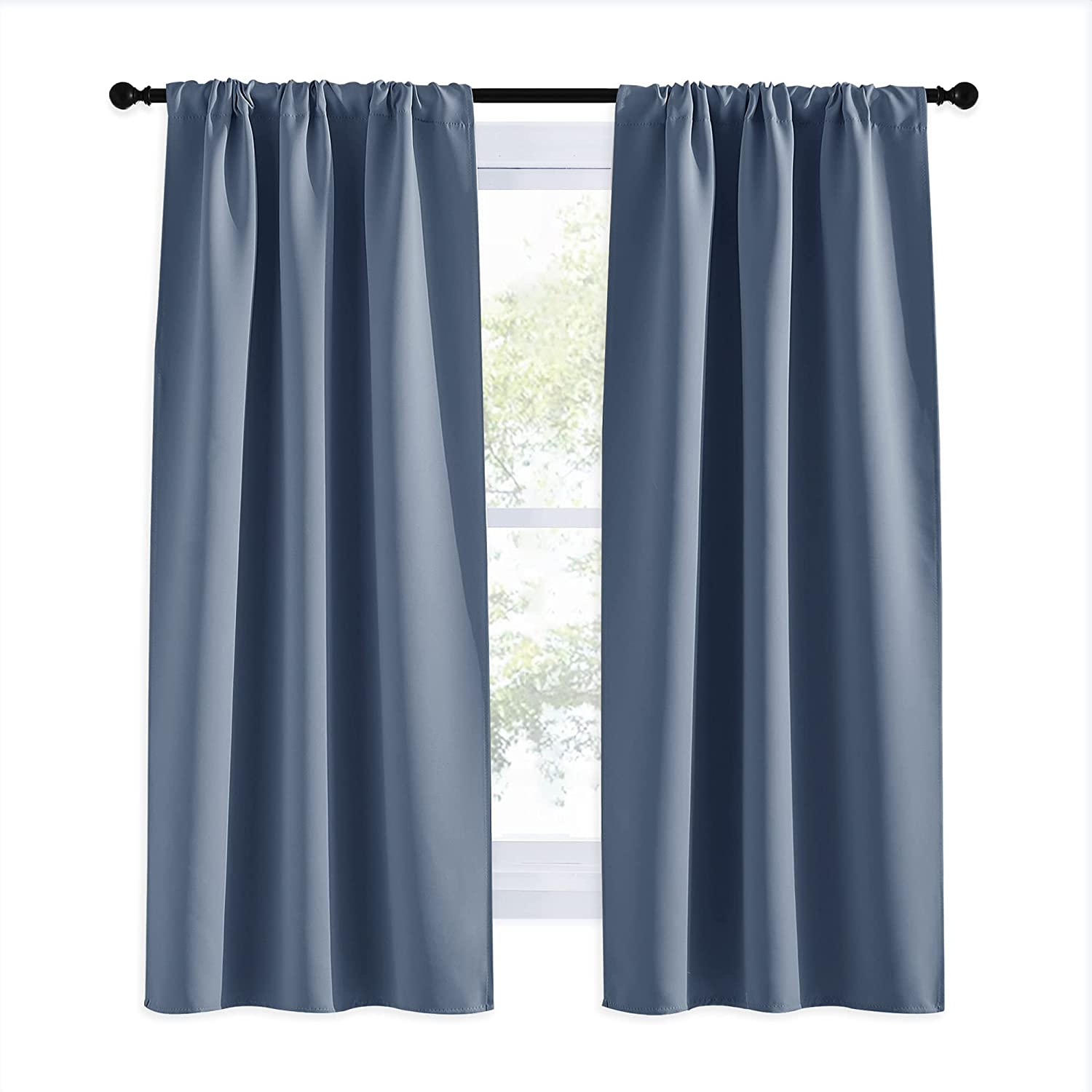 Pair of solid blue rod pocket thermal insulated blackout curtains hanging on a rod, ideal for living room & bedroom privacy.