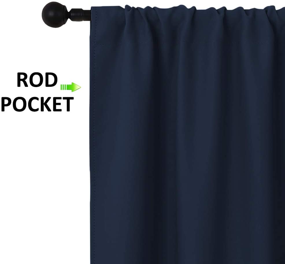 Navy blue thermal insulated blackout curtain with a prominent rod pocket header on a black rod.