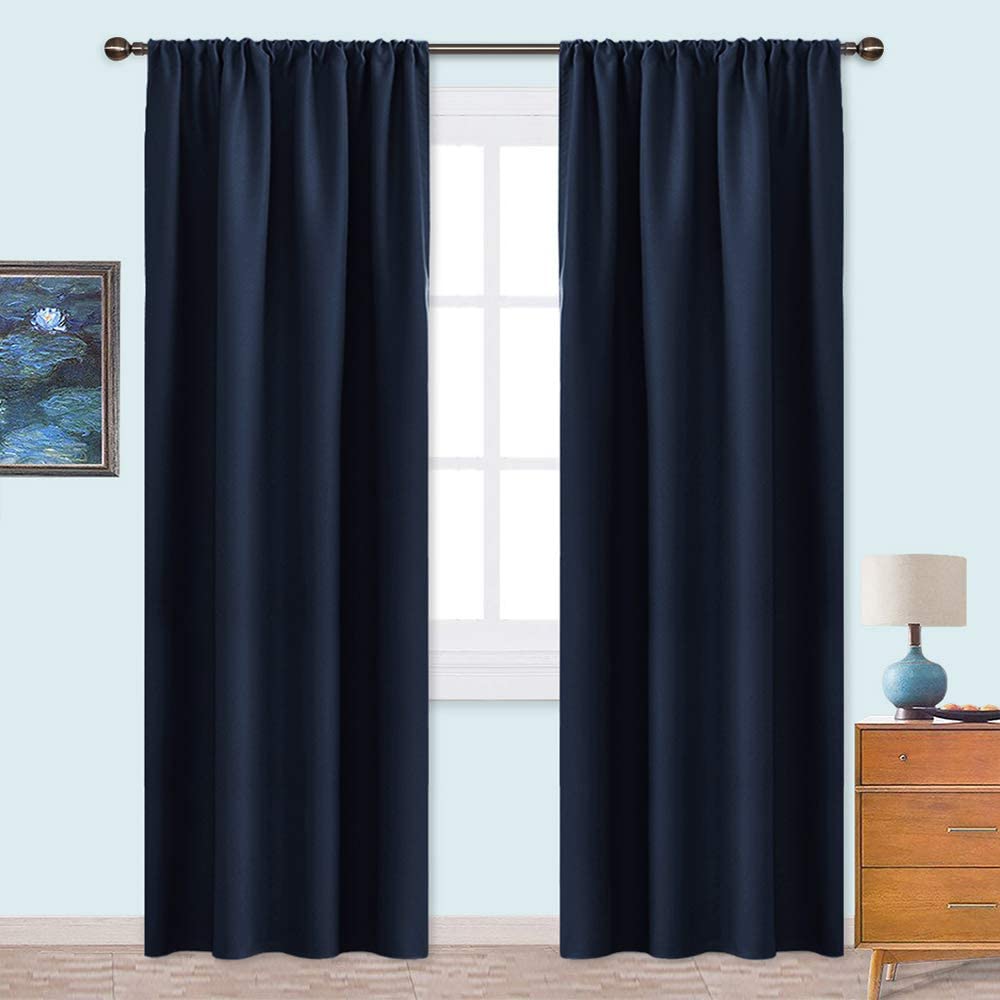 Navy triple weave blackout rod pocket curtains fully closed over a window, ideal for living room or bedroom privacy and light control.