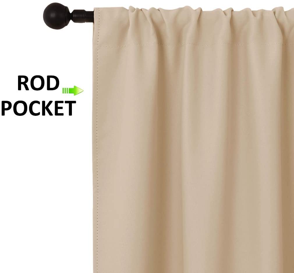 Close-up of a beige triple weave blackout curtain highlighting the rod pocket heading, neatly gathered on a black decorative rod.