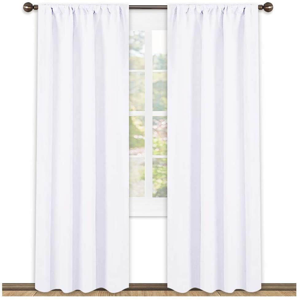 Crisp white triple weave blackout curtains, two panels, with rod pocket tops. Ideal for living room or bedroom privacy.