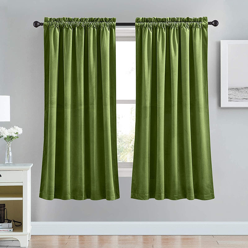 Two panels of vibrant green velvet rod pocket curtains, offering luxurious noise-reducing blackout for living room/bedroom.