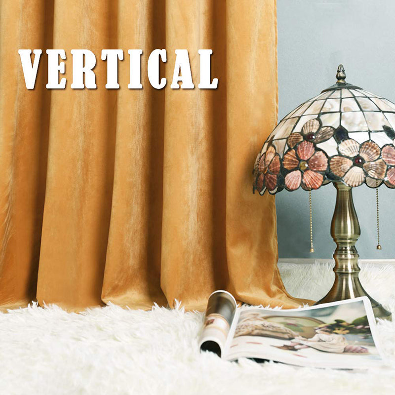 Golden velvet rod pocket blackout curtains with luxurious folds, complementing a patterned lamp and soft white rug for a chic living room.
