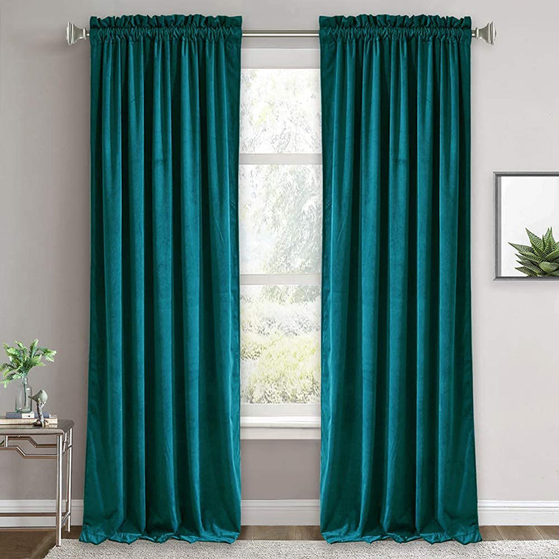 Two dark teal velvet rod pocket noise reducing blackout luxury curtains for living room or bedroom, enhancing privacy.