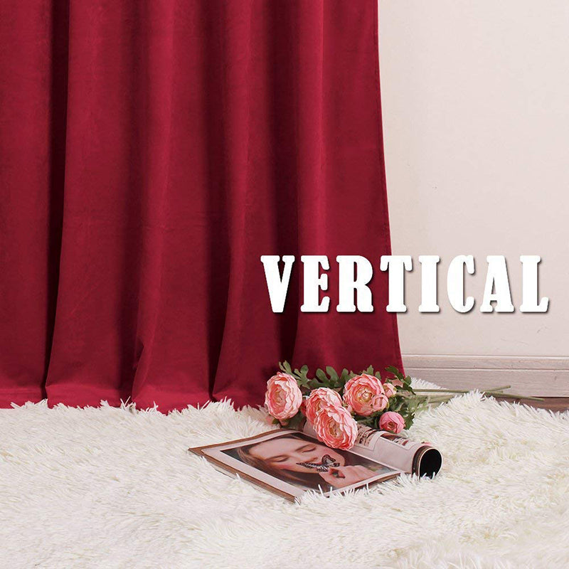 Deep red velvet rod pocket blackout curtain for living room or bedroom. Luxury noise-reducing fabric drapes softly over a white rug.