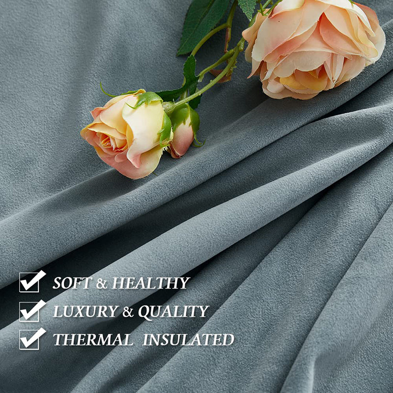 Soft, luxurious grey velvet blackout curtain fabric draped with pink roses. Emphasizes thermal insulation, noise reduction, & quality.