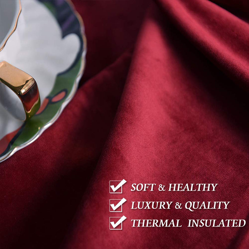 Close-up of luxurious dark red velvet blackout curtain fabric with elegant folds, highlighting soft texture and thermal insulation.