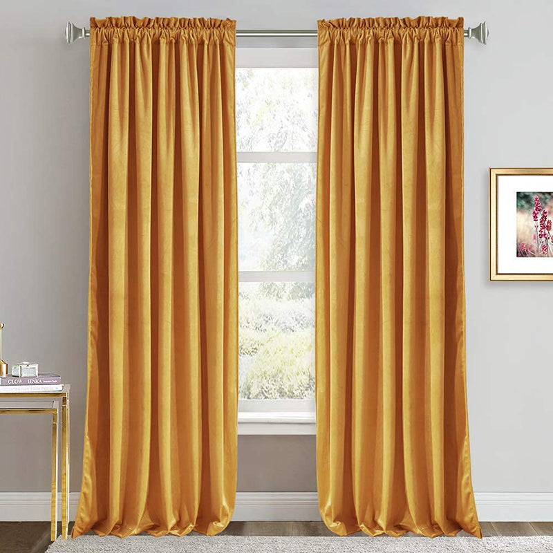 Two luxurious golden velvet rod pocket curtains, providing noise reducing blackout functionality for stylish living room or bedroom decor.