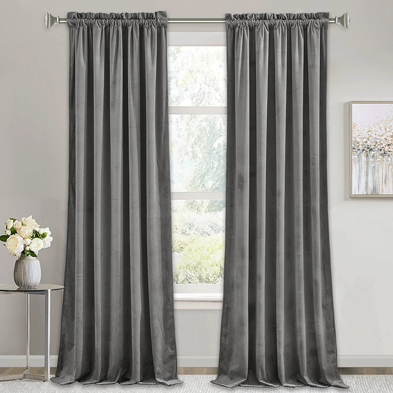 Two grey rod pocket velvet blackout curtains in a living room, ideal for noise reduction, luxury, and privacy in bedrooms.