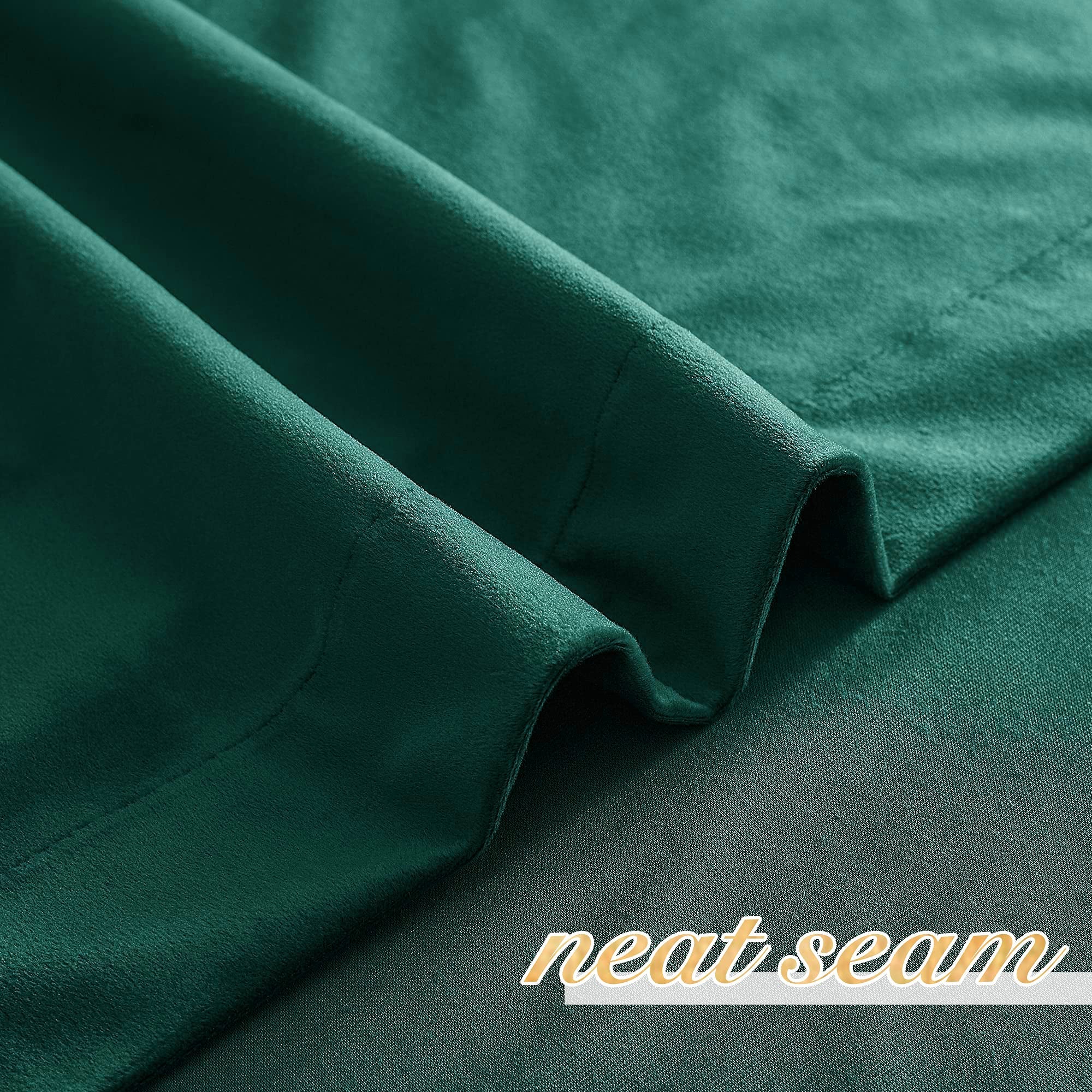 Deep green velvet rod pocket blackout curtain fabric with a neat seam, perfect for privacy in living rooms or bedrooms.