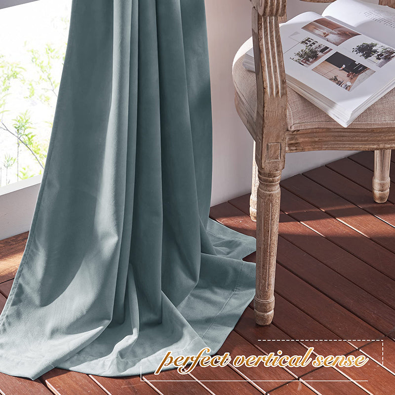 Plush teal velvet blackout curtain panel elegantly drapes on a wooden floor, enhancing living room or bedroom privacy.
