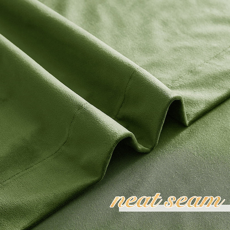 Close-up of plush green velvet privacy blackout curtain fabric, showing a neat seam detail for living room & bedroom.