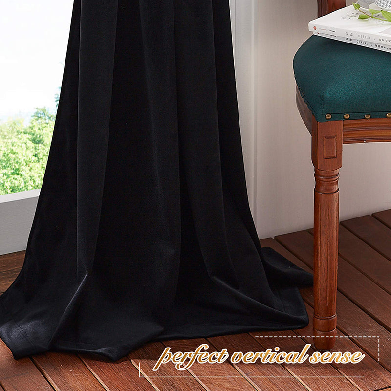 Rich black velvet rod pocket blackout curtain panel drapes to the floor, providing privacy for living room or bedroom.