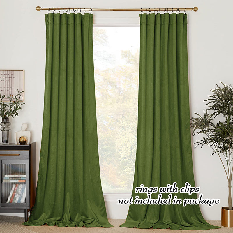 Two panels of green velvet rod pocket blackout curtains provide elegant privacy protection for a living room or bedroom window.