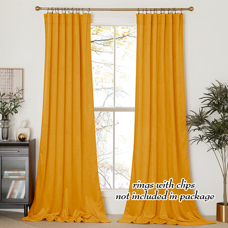Two panels of golden velvet rod pocket blackout curtains for living room and bedroom, offering privacy protection.