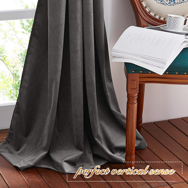 Dark grey velvet blackout curtain, rod pocket style, providing privacy protection in a living room or bedroom.