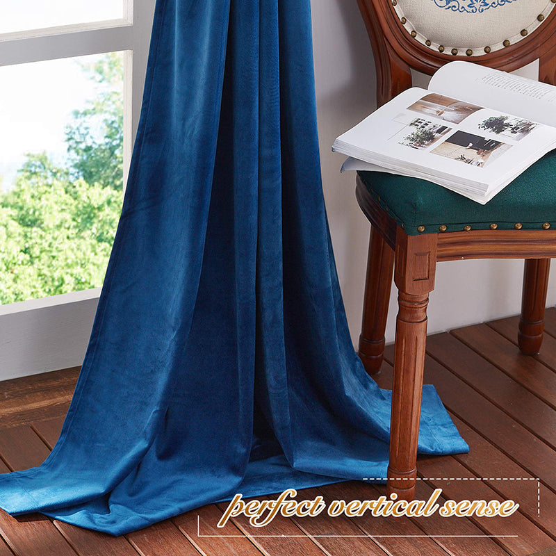 Deep blue velvet blackout privacy curtain draping elegantly on a wood floor, ideal for living rooms or bedrooms.