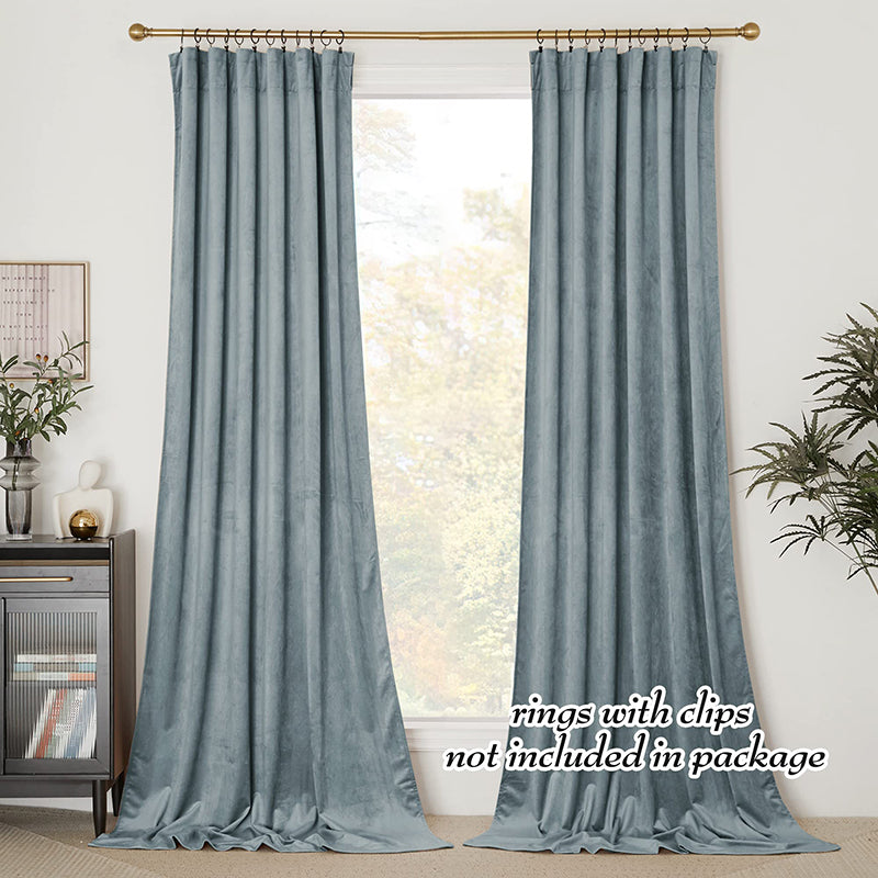 Two panels of dusty blue velvet rod pocket blackout curtains for living room or bedroom privacy protection.
