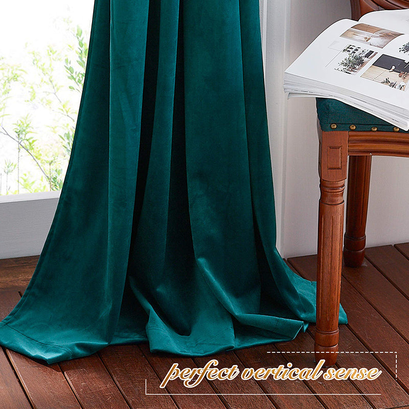 Rich teal velvet rod pocket blackout curtains elegantly pooling, offering luxurious privacy protection for living room or bedroom.